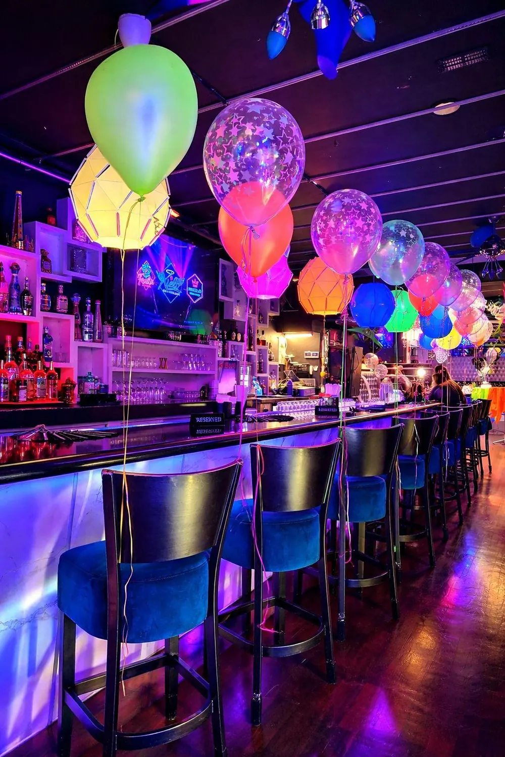 Xielo Lounge bar counter with neon-lit balloon decor