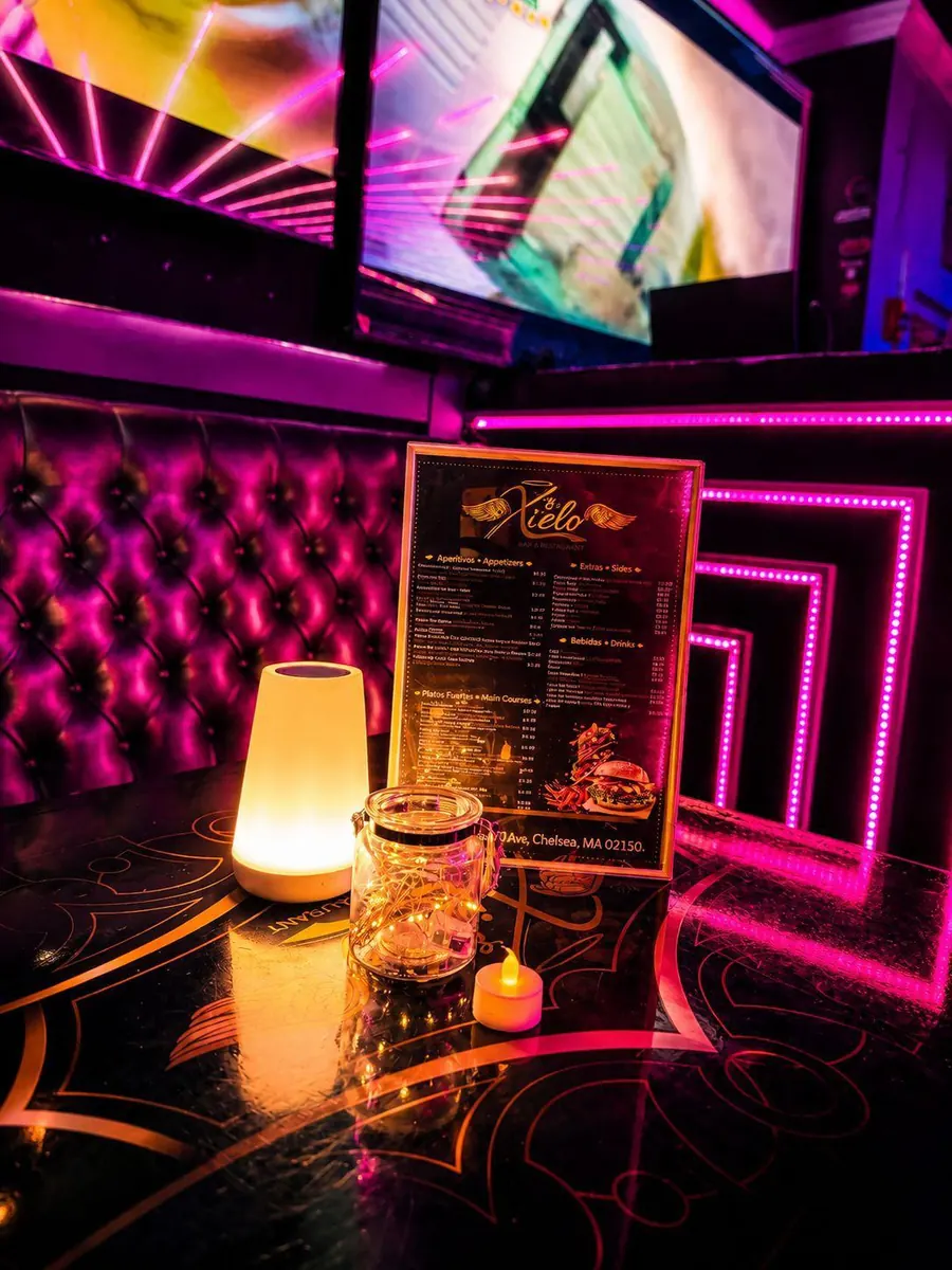 Xielo Lounge printed menu on a candlelit table