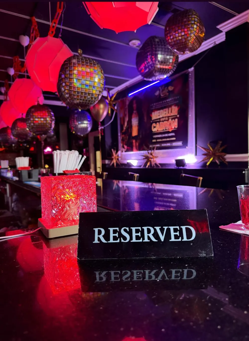 Reserved VIP table under hanging disco balls at Xielo Lounge
