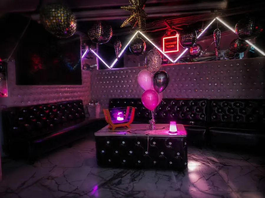 Xielo Lounge VIP booth with disco balls and neon sign